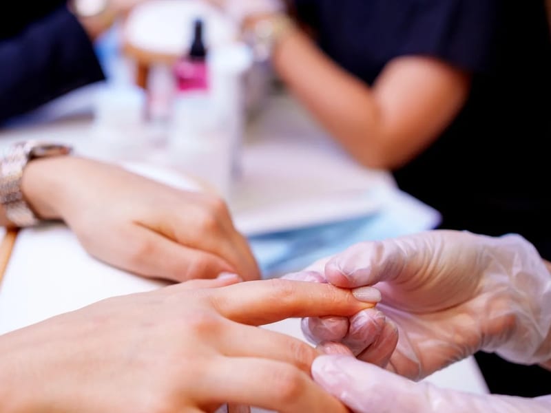 Nail instructor teaching students in the Touch of Class training studio